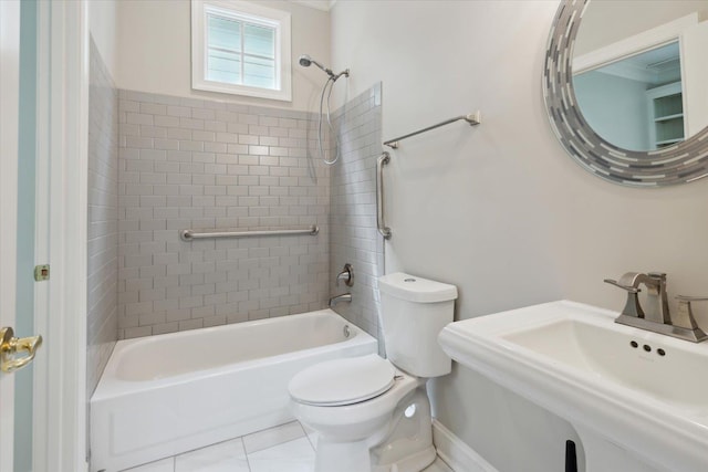 full bathroom with tiled shower / bath combo, sink, tile patterned flooring, and toilet