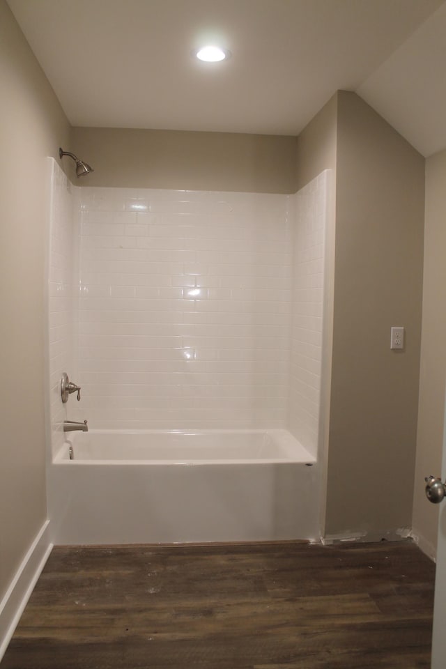 bathroom with tiled shower / bath and wood-type flooring