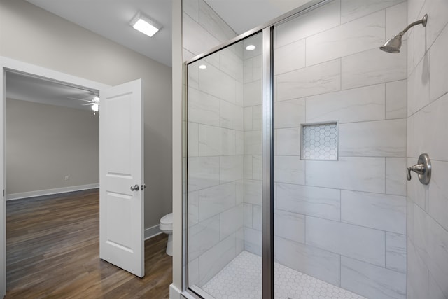 bathroom with ceiling fan, wood-type flooring, toilet, and an enclosed shower