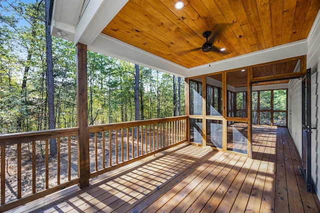 deck with a sunroom and ceiling fan