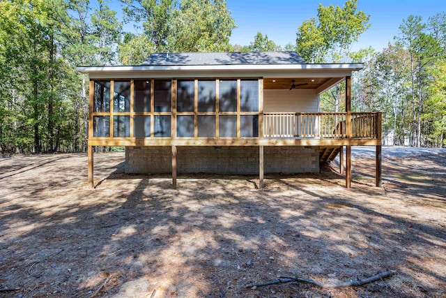 back of house featuring ceiling fan, a deck, and a sunroom