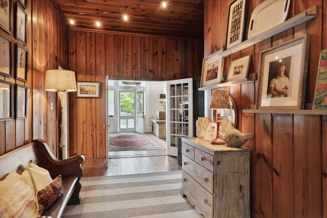 interior space with wood walls and wood-type flooring