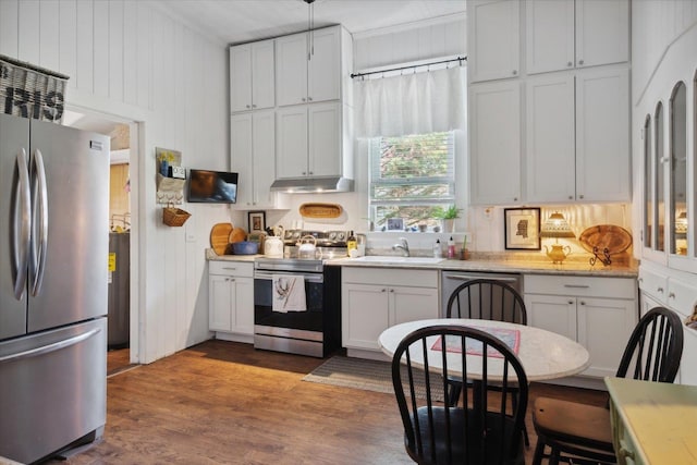 kitchen featuring dark hardwood / wood-style floors, stainless steel appliances, sink, and white cabinets