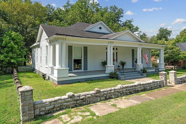 view of front of property with covered porch and a front yard