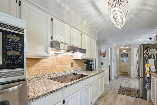 kitchen with a notable chandelier, light wood-type flooring, white cabinets, backsplash, and stainless steel appliances