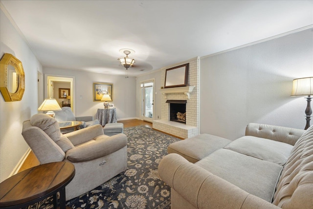 living room with brick wall, ornamental molding, wood-type flooring, and a brick fireplace