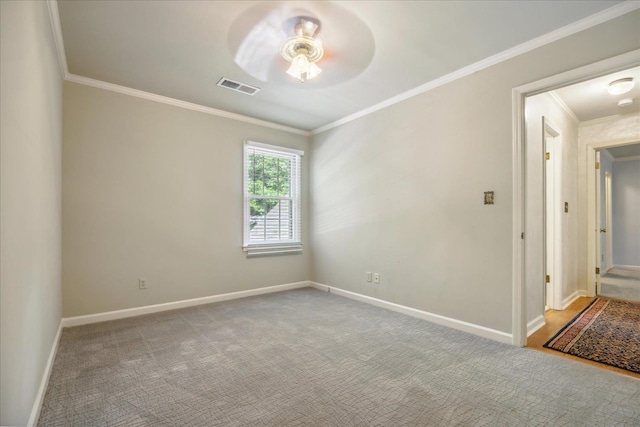 carpeted empty room with ceiling fan and crown molding