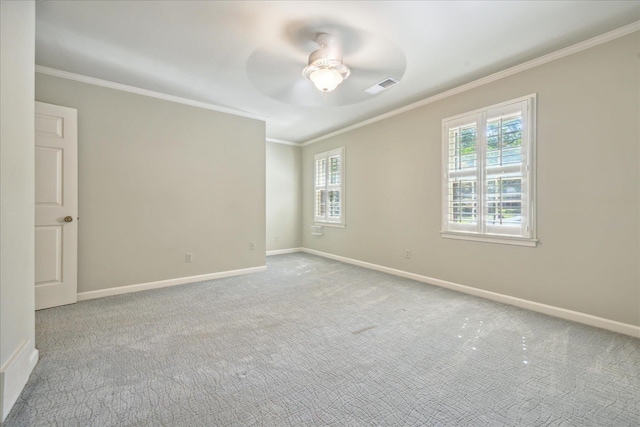 carpeted spare room featuring crown molding and ceiling fan