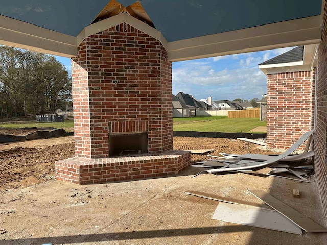 view of patio / terrace featuring an outdoor brick fireplace