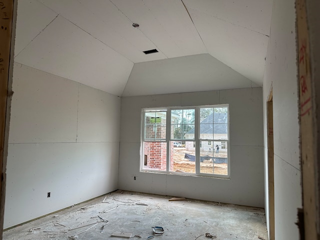 spare room featuring lofted ceiling