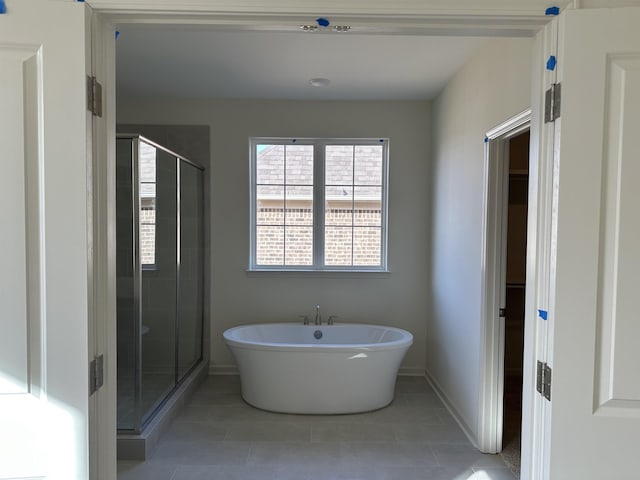 bathroom with tile patterned floors and plus walk in shower