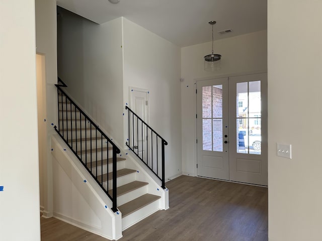 foyer entrance featuring dark hardwood / wood-style floors and french doors