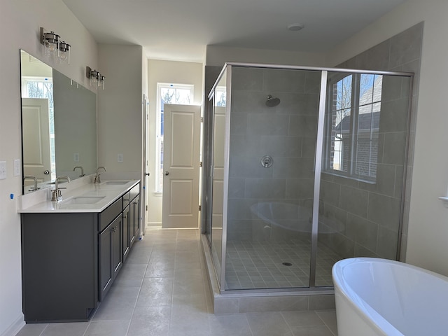 bathroom with vanity, a wealth of natural light, and separate shower and tub