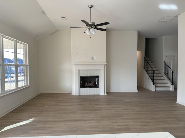 unfurnished living room featuring vaulted ceiling, ceiling fan, and hardwood / wood-style floors