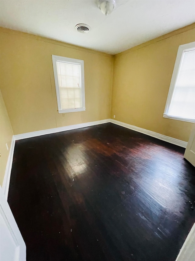 spare room with dark hardwood / wood-style floors