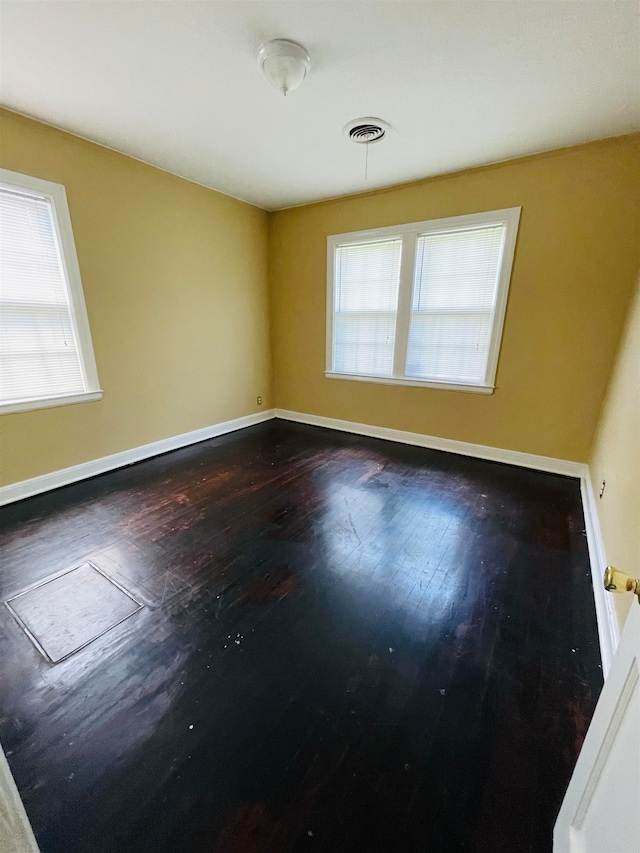 unfurnished room featuring dark hardwood / wood-style flooring