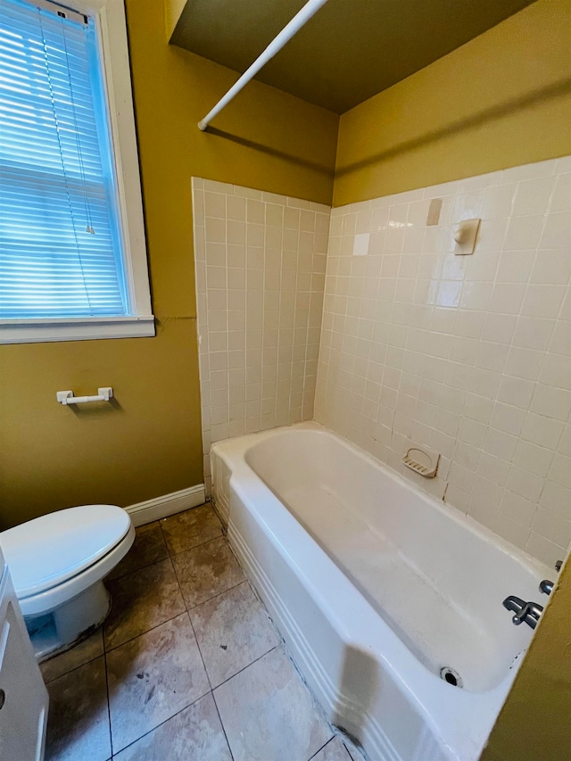 bathroom with tile patterned flooring, shower / bathtub combination, and toilet