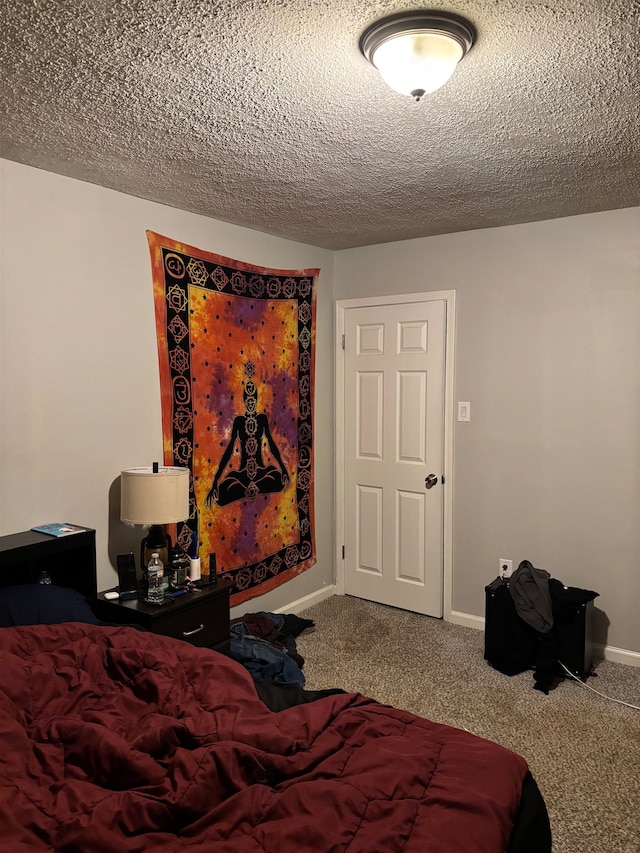 carpeted bedroom featuring a textured ceiling