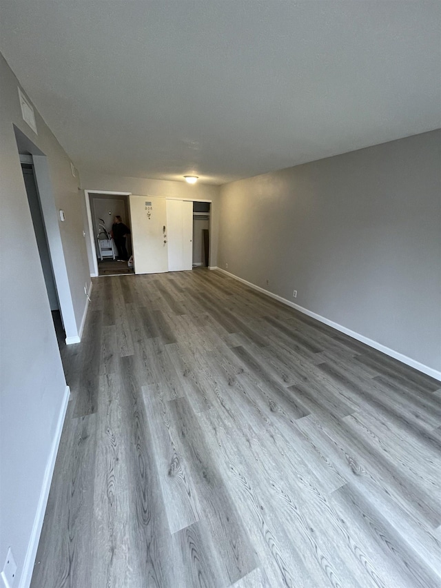 interior space featuring baseboards and wood finished floors