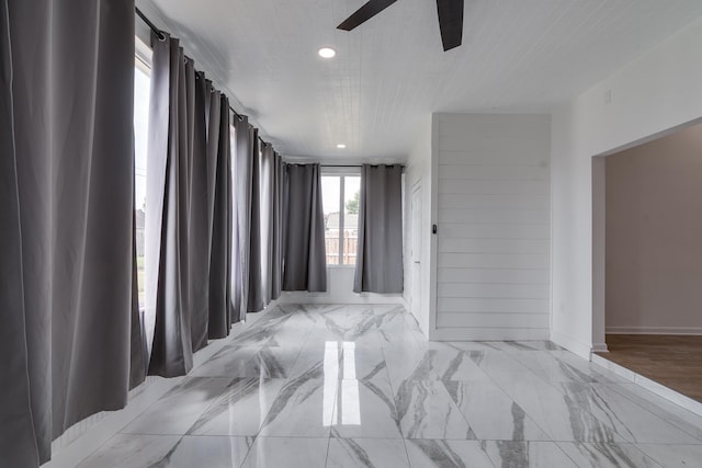 empty room with light tile patterned flooring and ceiling fan