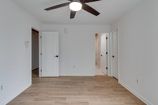 interior space with ensuite bath and ceiling fan