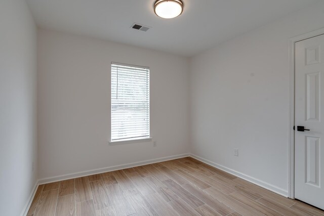 unfurnished room with light hardwood / wood-style floors