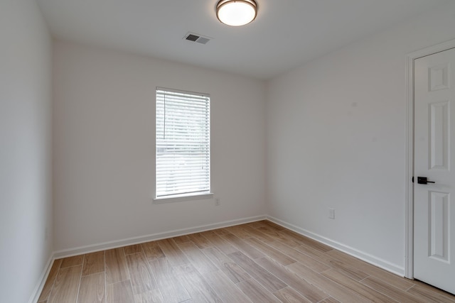 unfurnished room with light wood-type flooring