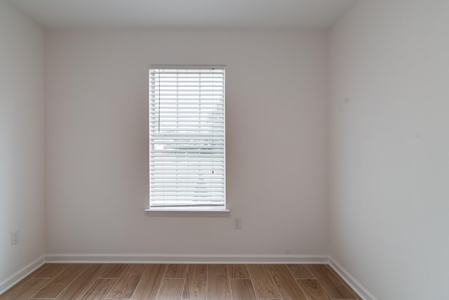 unfurnished room featuring hardwood / wood-style flooring and a wealth of natural light