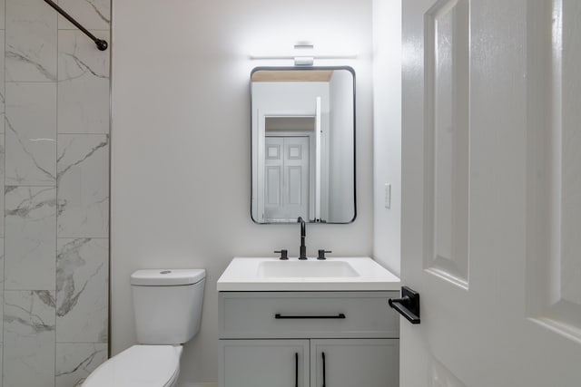 bathroom featuring toilet and vanity