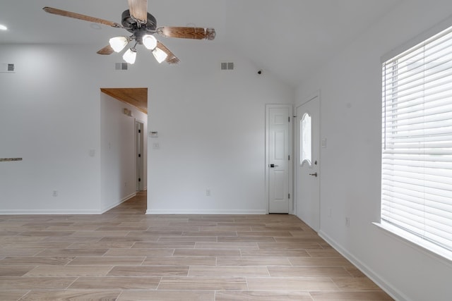 spare room featuring vaulted ceiling and ceiling fan