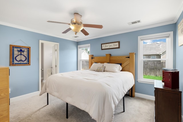 bedroom with crown molding, connected bathroom, light colored carpet, and ceiling fan