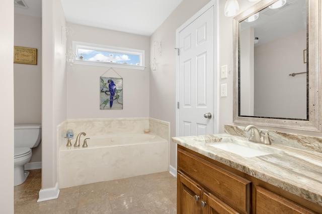 bathroom with tile patterned floors, a bath, toilet, and vanity