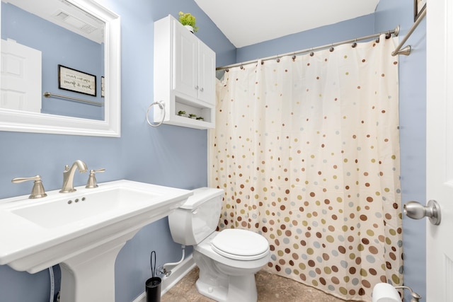 bathroom with toilet and tile patterned floors