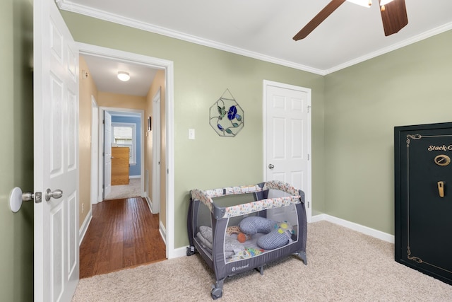 interior space with crown molding, ceiling fan, and carpet flooring