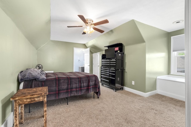 carpeted bedroom with vaulted ceiling and ceiling fan