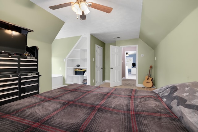 carpeted bedroom with ceiling fan and vaulted ceiling