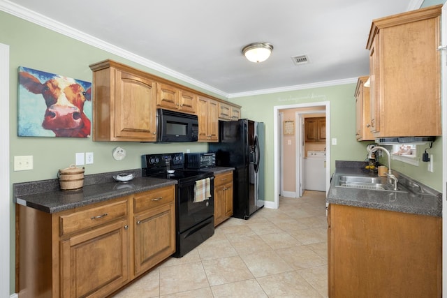 kitchen featuring light tile patterned floors, black appliances, washer / dryer, sink, and ornamental molding