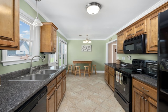 kitchen featuring a notable chandelier, light tile patterned floors, black appliances, pendant lighting, and sink