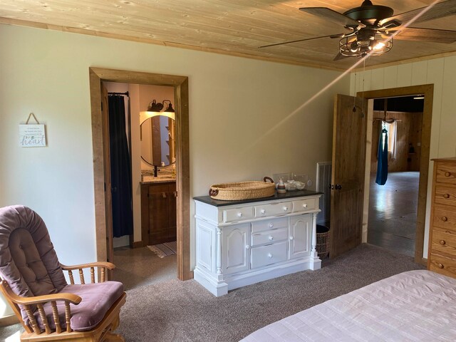 bedroom with ceiling fan, carpet flooring, ensuite bath, and wooden ceiling