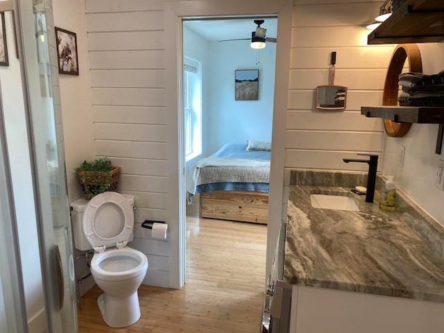 bathroom with vanity, ceiling fan, hardwood / wood-style flooring, and toilet