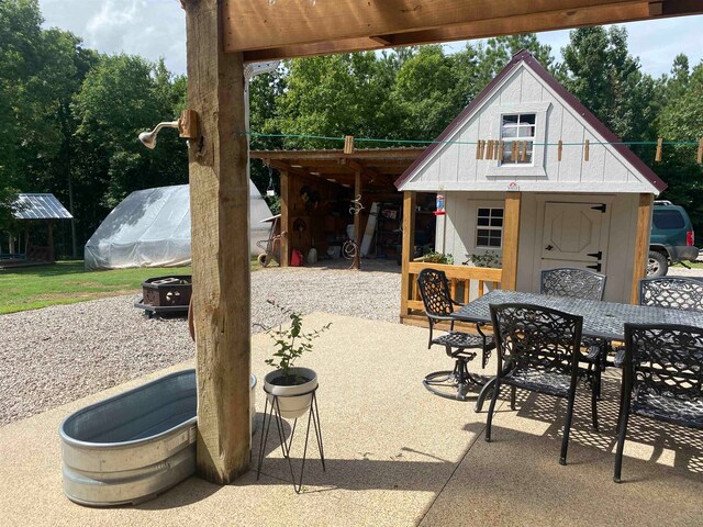 view of patio featuring an outbuilding