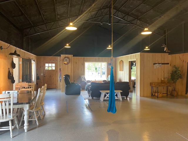 interior space with a towering ceiling and wooden walls