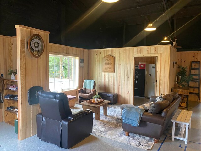 living room featuring a high ceiling and wooden walls