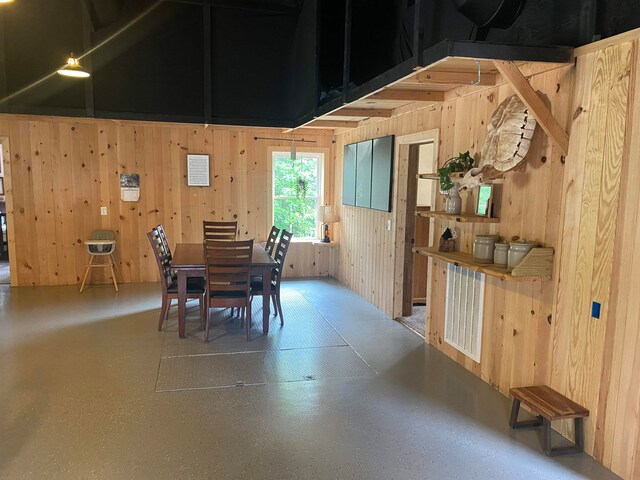 dining area featuring wooden walls