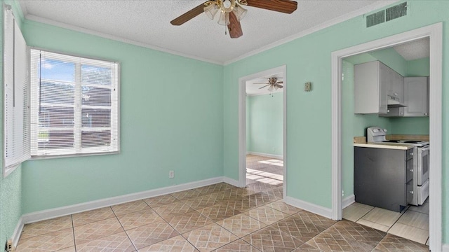 interior space featuring light tile patterned floors, a textured ceiling, ceiling fan, and crown molding