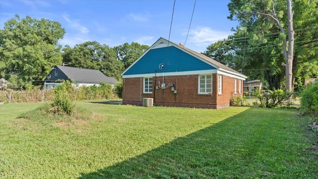 view of property exterior featuring central AC and a lawn