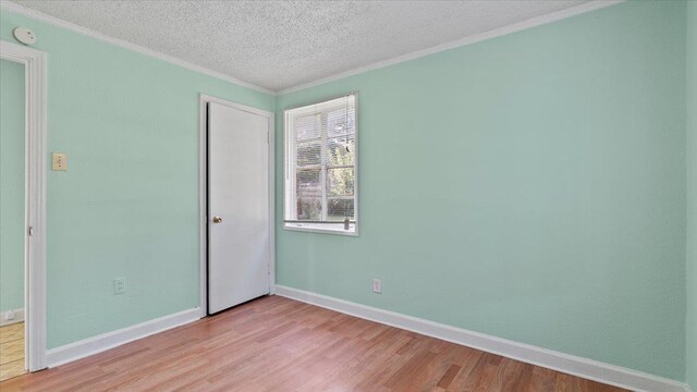 unfurnished bedroom featuring a textured ceiling and light hardwood / wood-style flooring