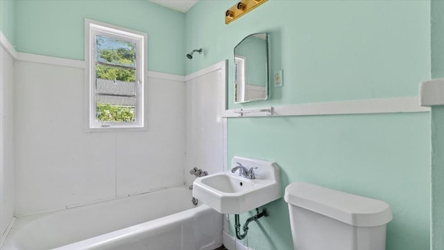 bathroom with washtub / shower combination and toilet