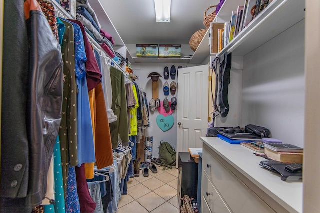 walk in closet with light tile patterned floors