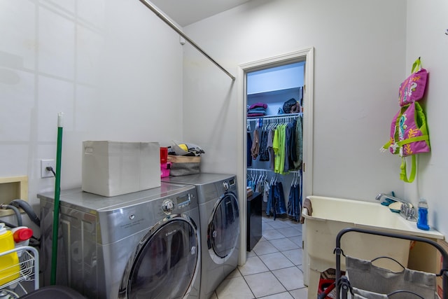 clothes washing area with laundry area, light tile patterned floors, and independent washer and dryer